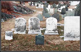 Headstone of Elizabeth Pitman (1684) surrounded by larger stones.